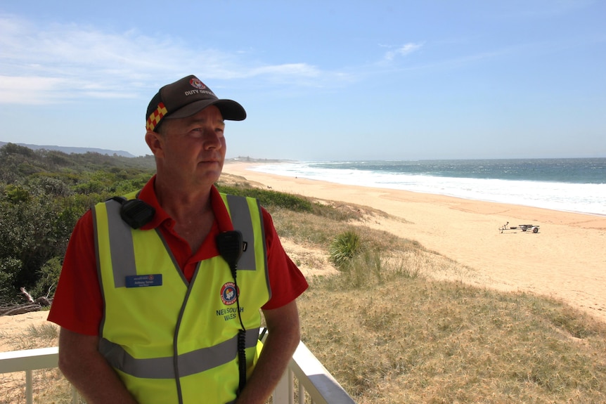 Image of man in high-vis and life saving uniform on beach