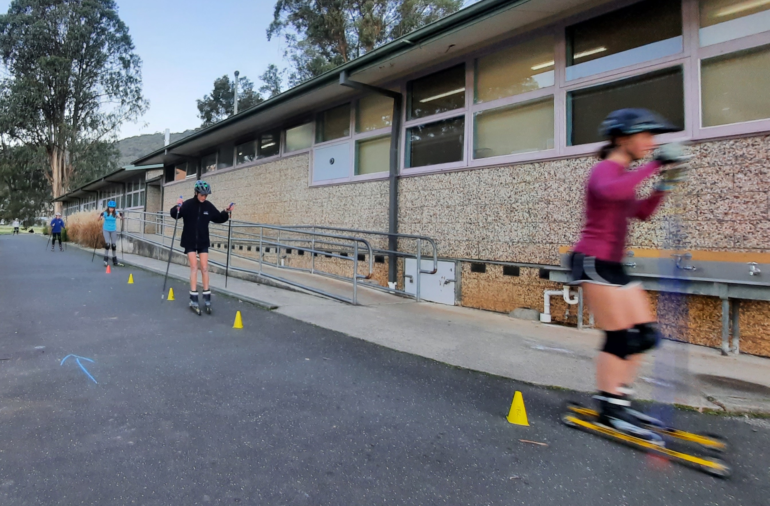 Children ski on a road