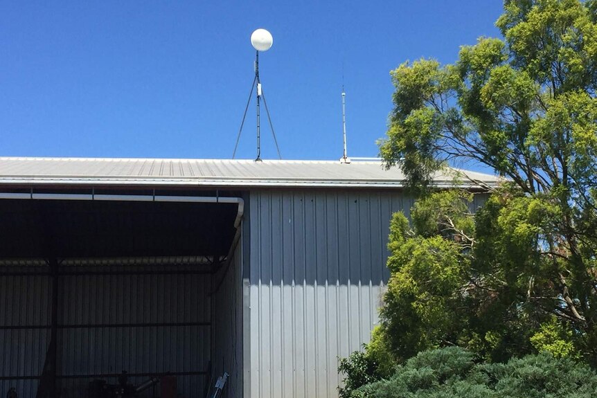 A dish installed on top of a farming shed at Bowenville near Dalby