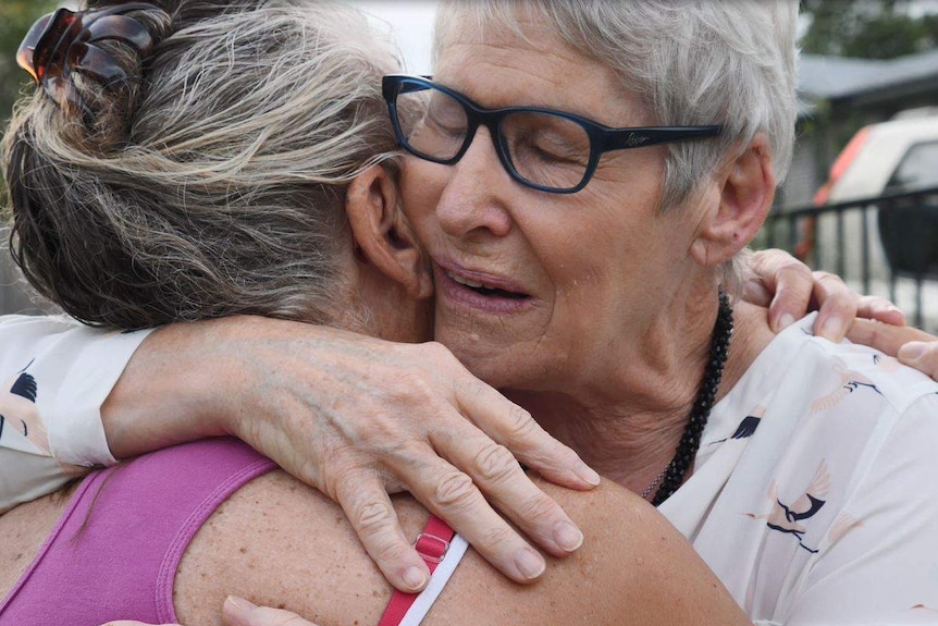 Christine Archer embraces her younger sister Gail Baker when they were reunited in Bowraville this week.