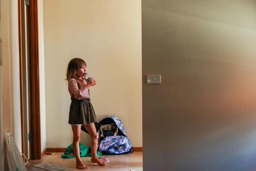 A girl standing in the entry to her family's new home