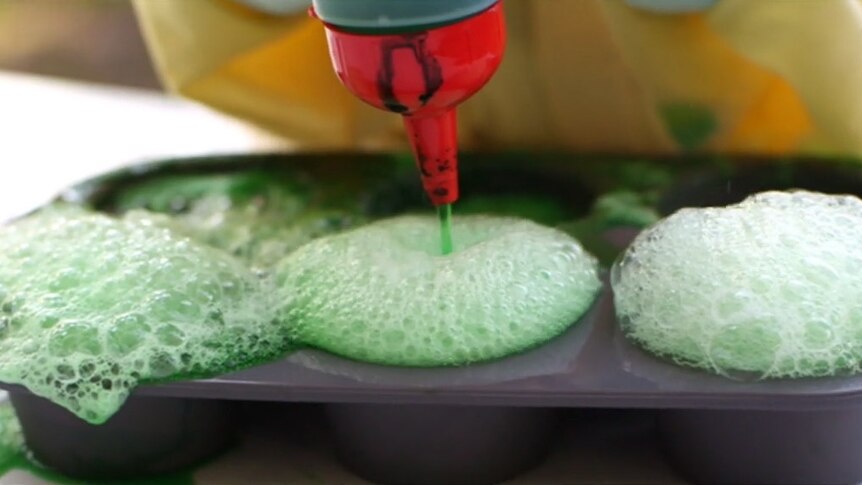 Pouring green liquid into a tray