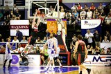 Hawks forward AJ Ogilvy jumps up to dunk the basketball against Adelaide in the WIN Entertainment Centre.