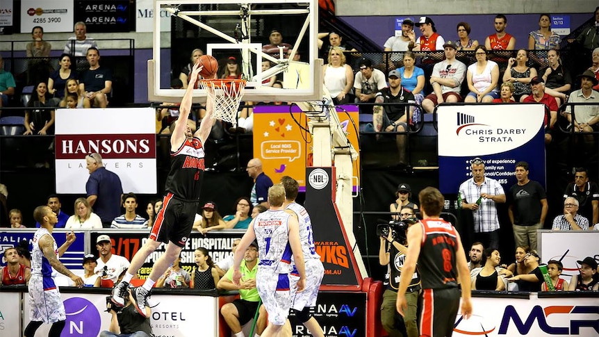 Hawks forward AJ Ogilvy jumps up to dunk the basketball against Adelaide in the WIN Entertainment Centre.