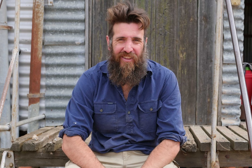 Ray Kingston sitting outside his wool shed on his farm in western Victoria