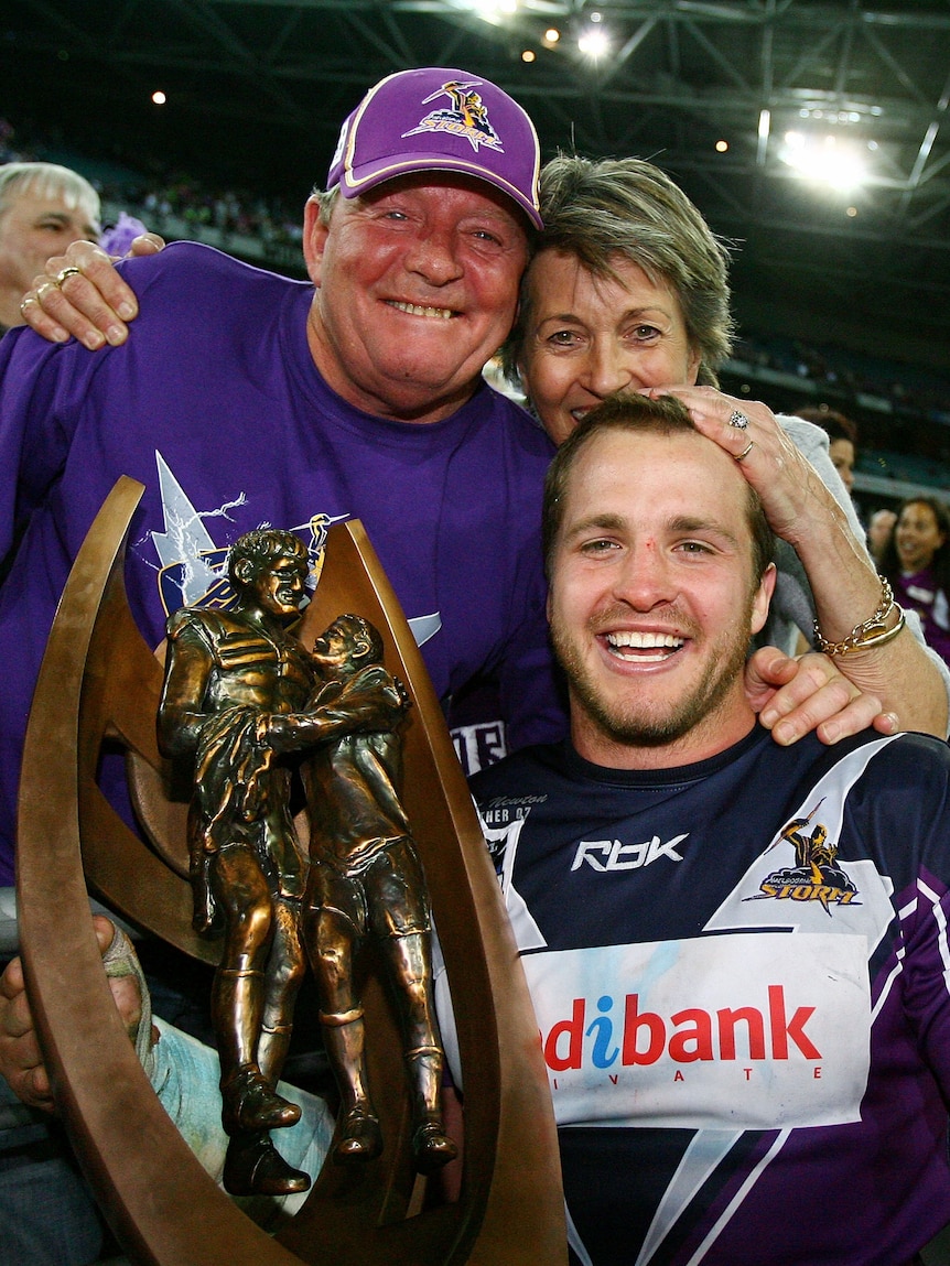 A family of rugby league fans celebrates after winning a trophy in Australia