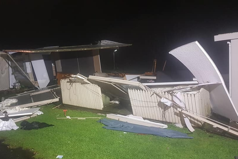 Walls and fences are strewn about in a caravan park.
