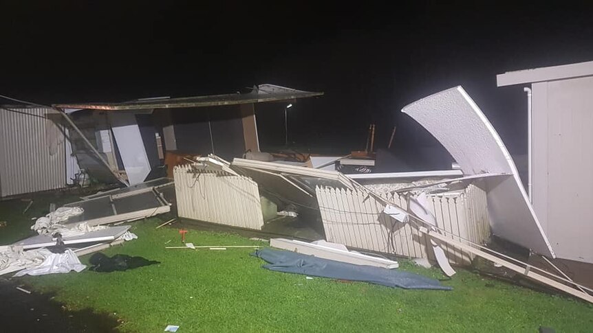Walls and fences are strewn about in a caravan park.