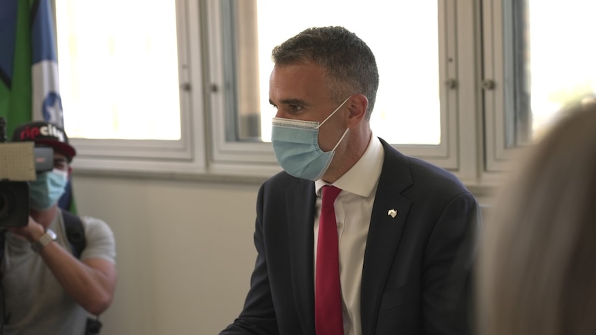 New SA Premier Peter Malinauskas sits at a desk as he meets with the police commissioner.