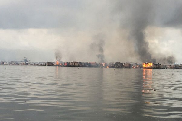 Shanties by the water on fire
