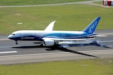 The Boeing 787 Dreamliner touches down at Sydney International Airport.