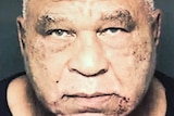 Samuel Little stares directly at the camera with a neutral expression in grainy mugshot.