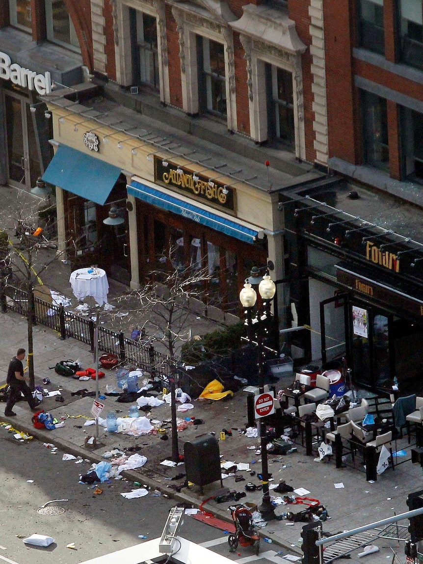 Debris lays strewn in front of shops after explosions.