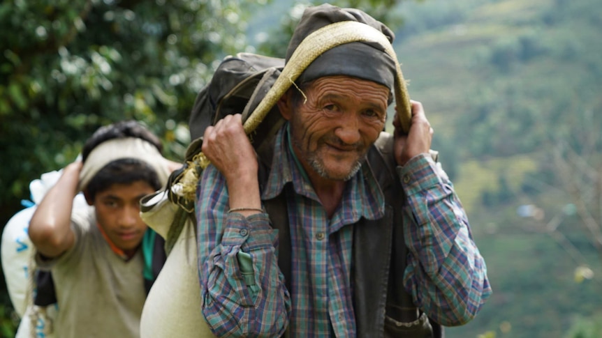 Villagers carry supplies to Bigu, Nepal