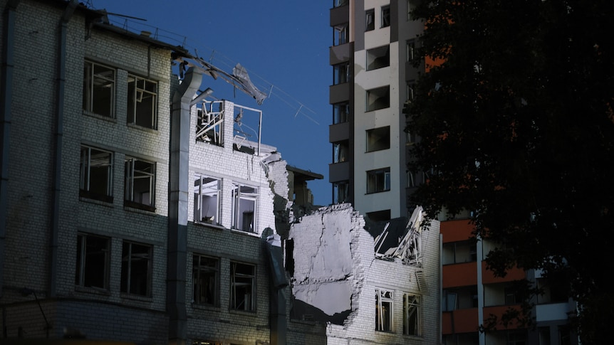 Damage to a residential building at night. 