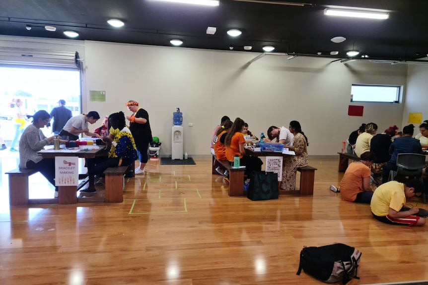 A group of students working in a hall
