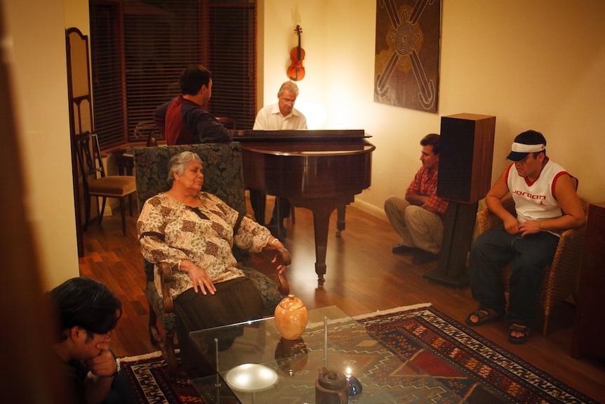 An evening gathering around the piano with Lowitja O'Donoghue and some Afghan refugees.