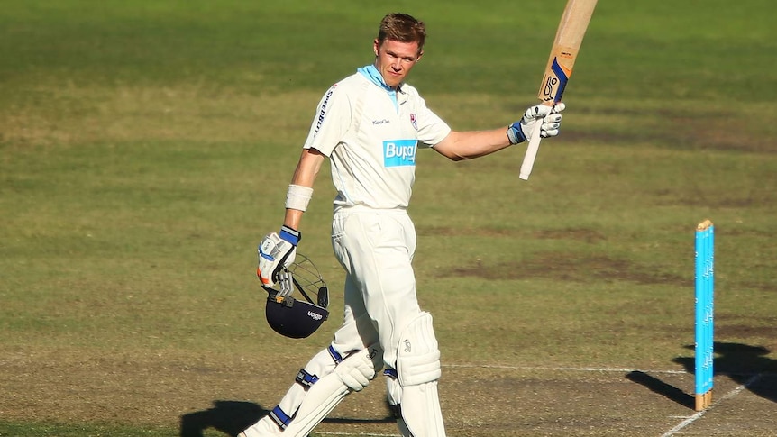 Scott Henry celebrates reaching his 150 for the Chairman's XI against Sri Lanka in Canberra.