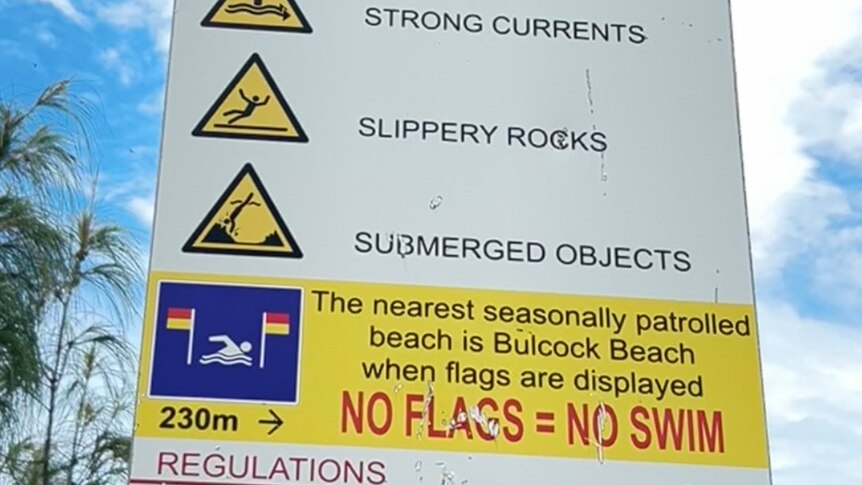 Beach sign with warnings