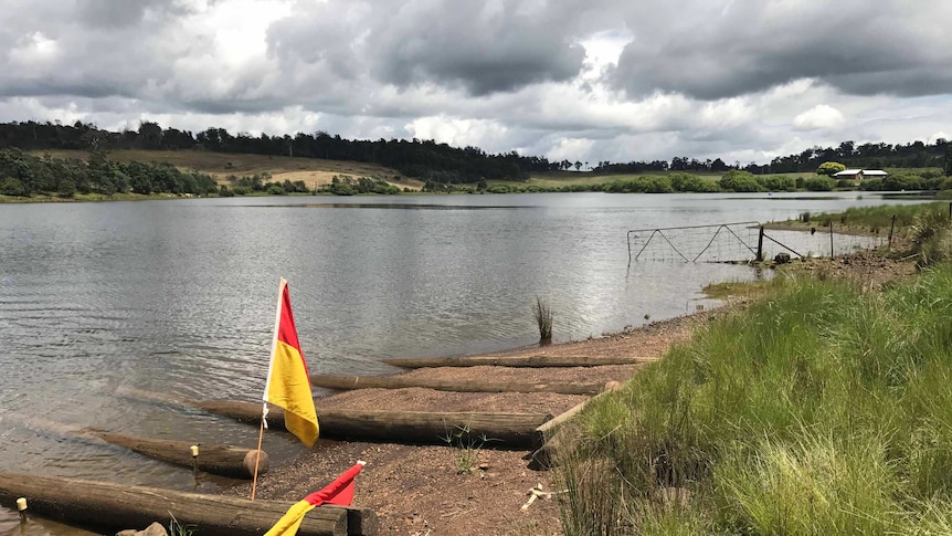 The picturesque Trevallyn Dam with life saving flags.