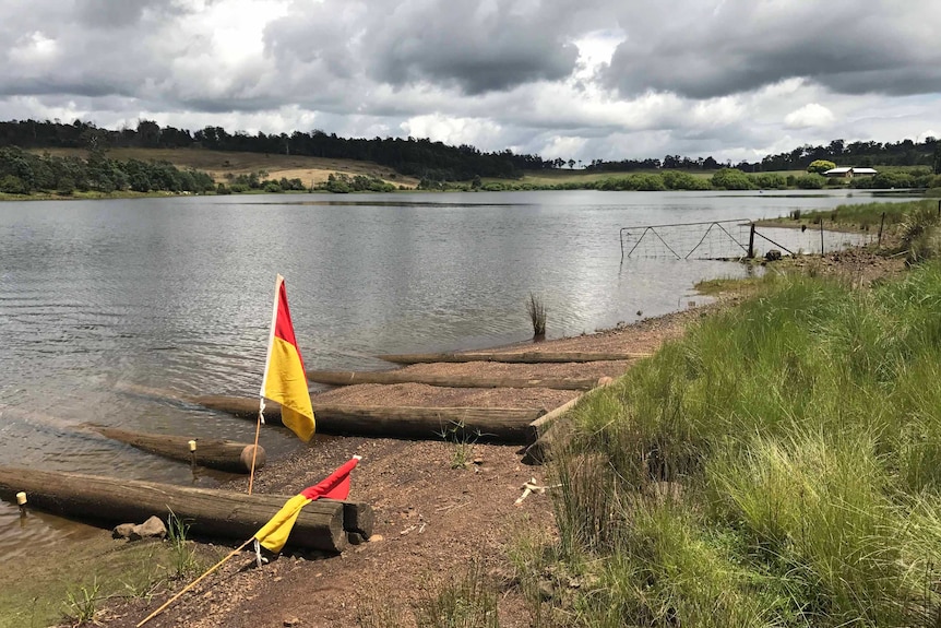 The picturesque Trevallyn Dam with life saving flags.