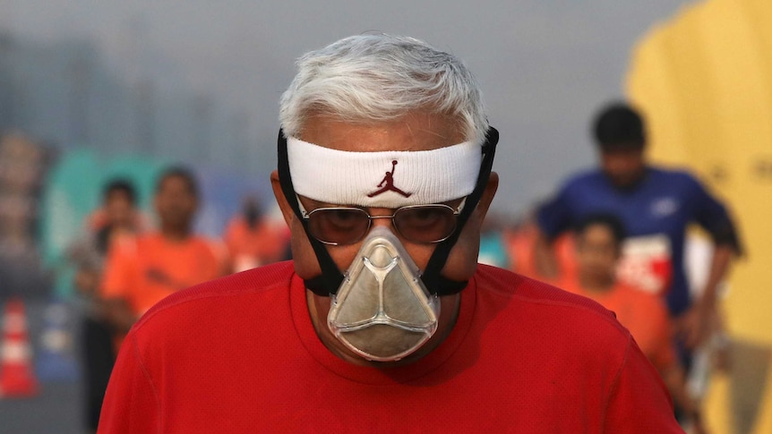 A man wears a face mask whilst running a marathon in New Delhi.