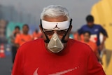 A man wears a face mask whilst running a marathon in New Delhi.