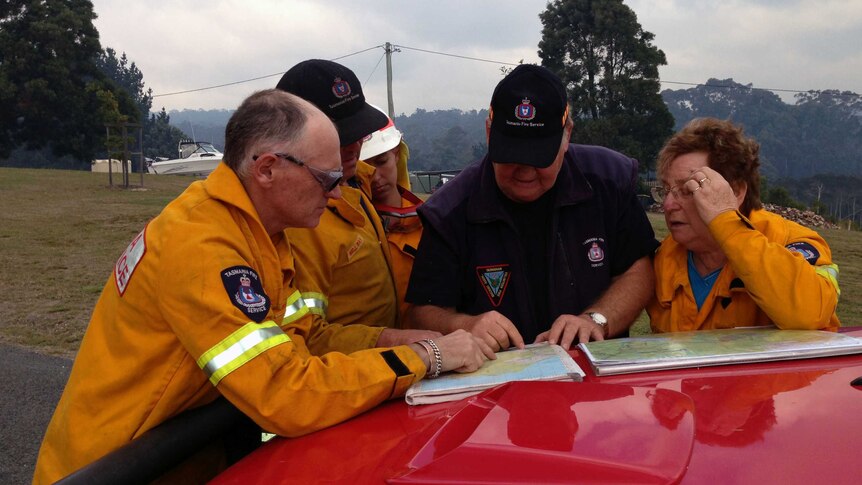 Fire crews look at a map to plan firefighting activities.
