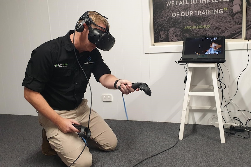 EmergiSim co-founder Mike Brewer demonstrates the use of VR headset and hand controllers. 