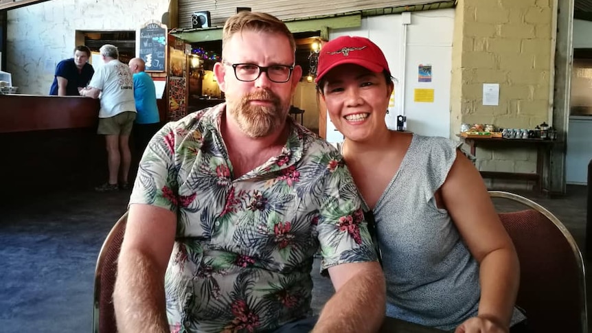 An Australian man and his wife pose for a photo in Borneo