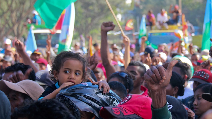 A child at an election rally in the Aileu district