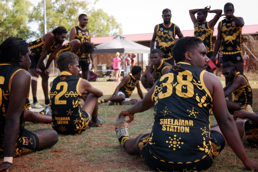 Bidyadanga Emu's men's team in a huddle during a football match June 2022. 
