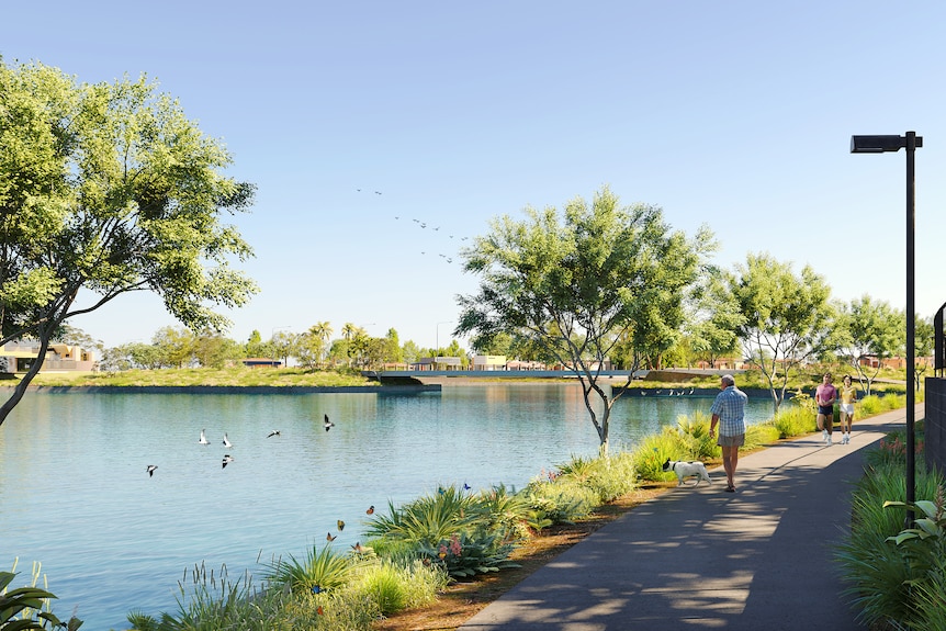 People walking along a path alongside a large lake