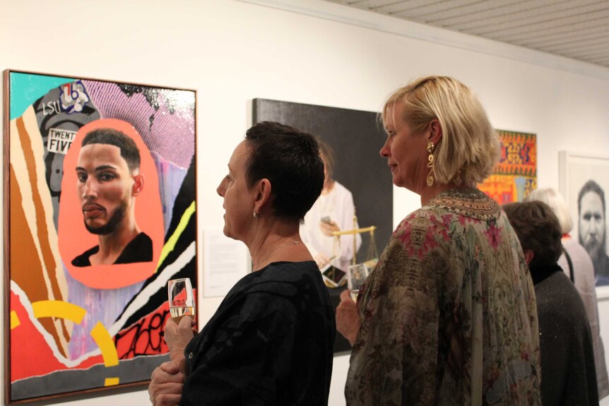 women gather in an art gallery