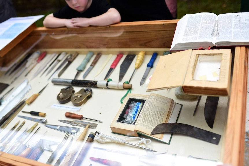 A glass display of prison-made weapons