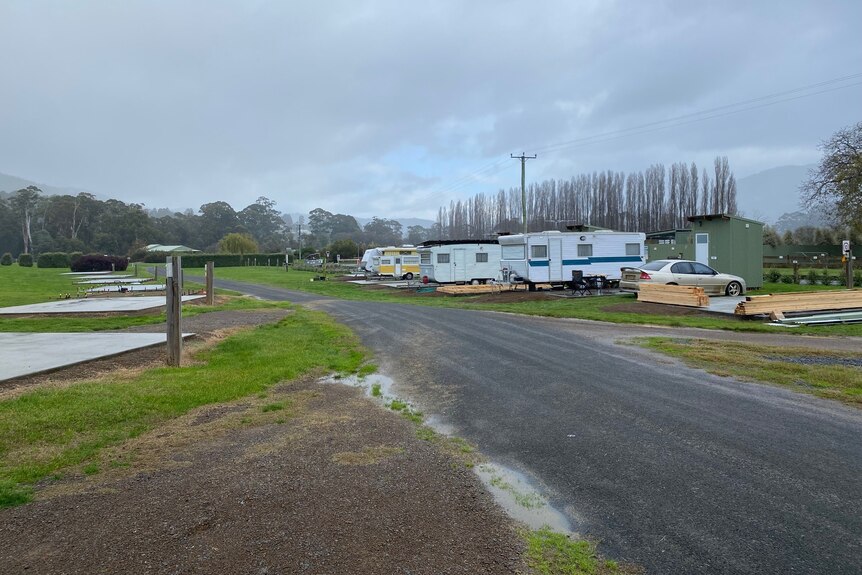Empty sites and vans at a caravan park.