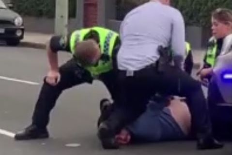 Still from video of John Saether being arrested by Tasmania Police