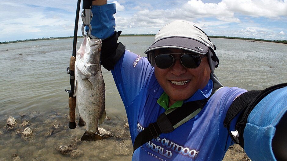 Hiroaki Nakamura celebrates after capturing his 1000th barramundi