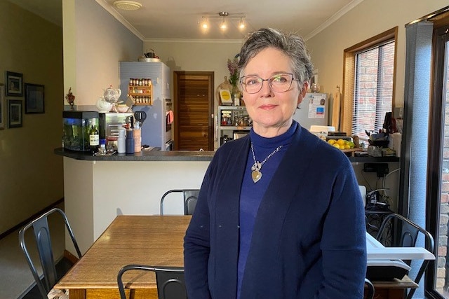 A woman standing in a kitchen