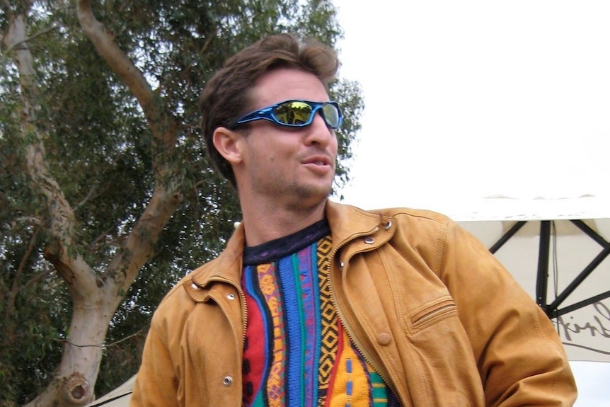 Tony Pecora wears a colourful jumper