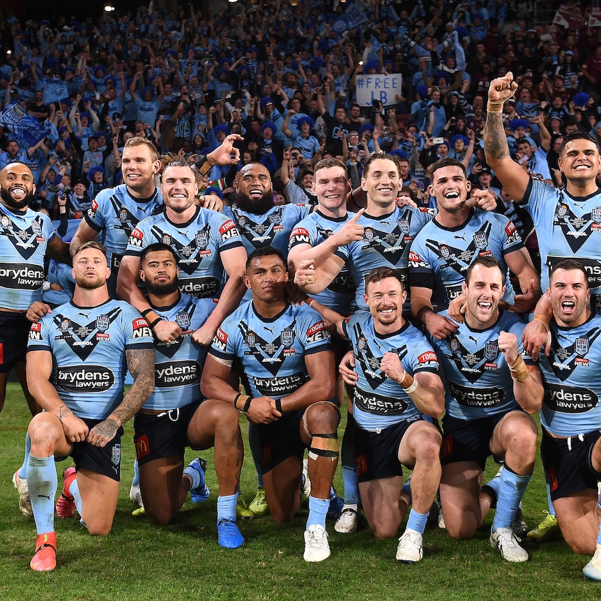NSW Blues players pose for a celebratory photo on the field after winning the 2021 State of Origin series.