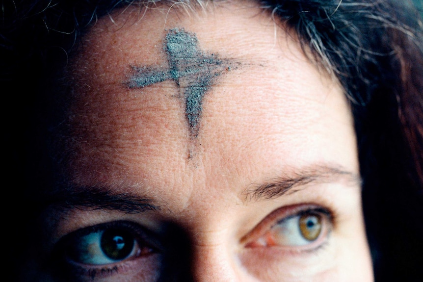 Woman with cross on forehead for Lent