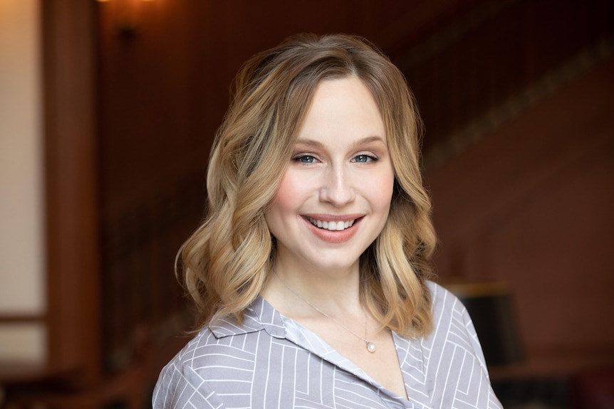 Portrait of a woman with shoulder length dark blonde hair and nice smile.