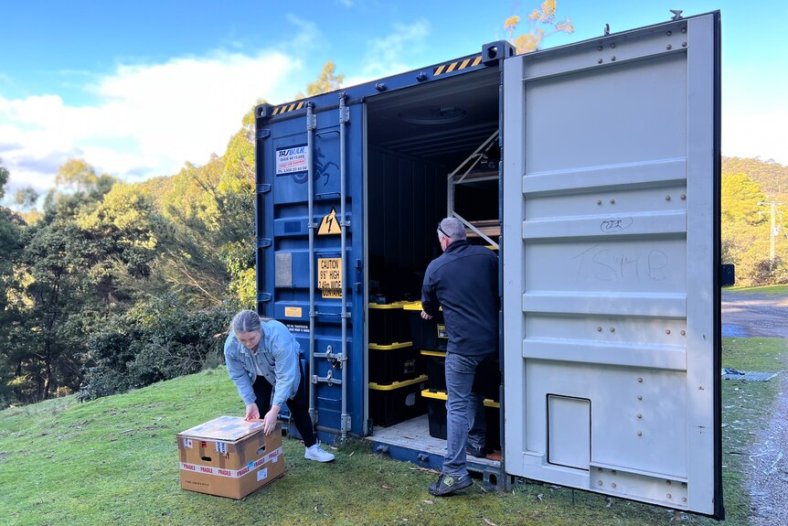 Tasha Jordan and Ken Belbin looking for things from their shipping container.