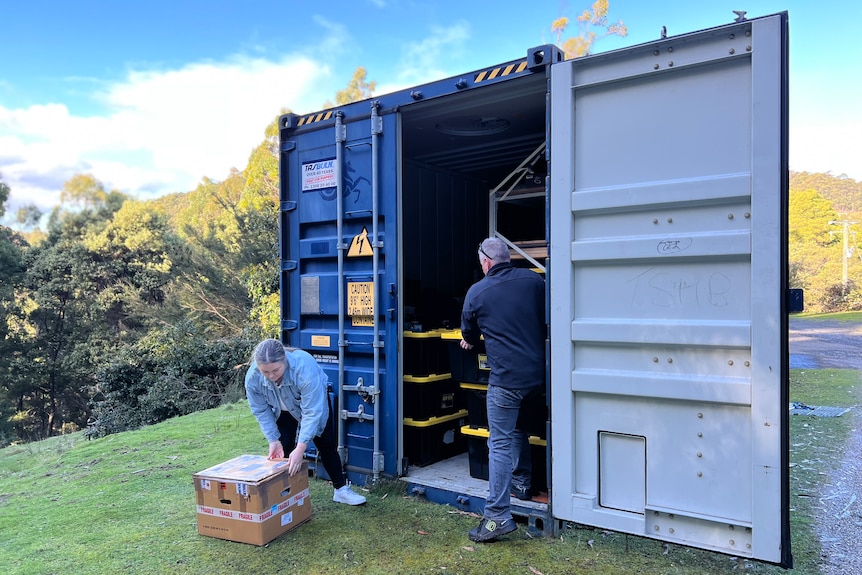 Tasha Jordan and Ken Belbin looking for things from their shipping container.