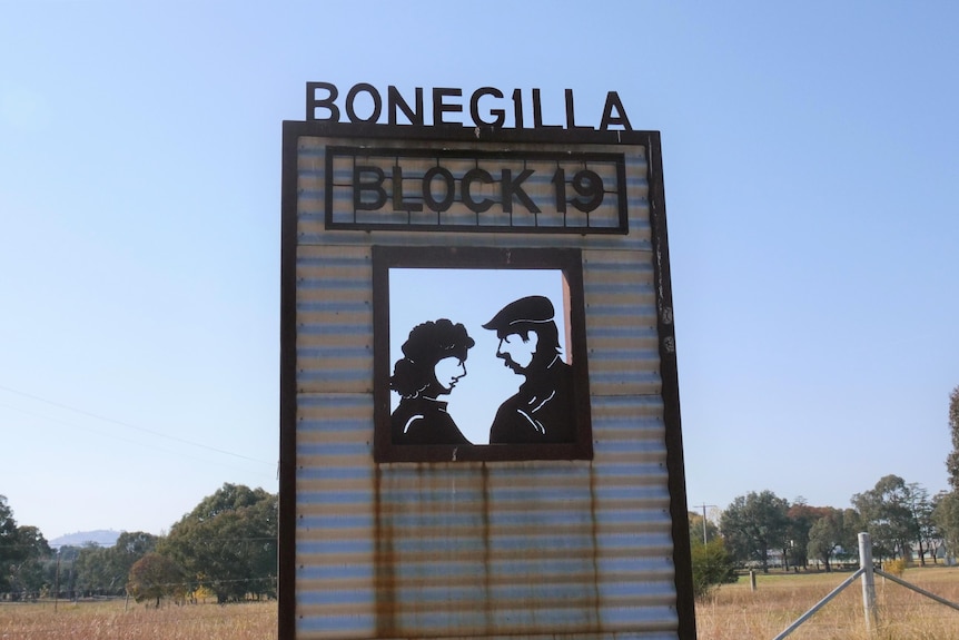 A sign in a country paddock made of corrigated iron 