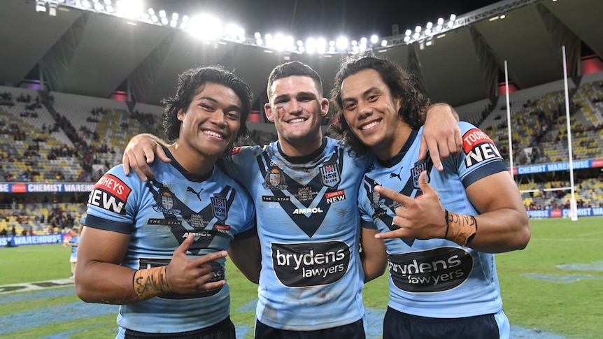 Brian To'o, Nathan Cleary and Jarome Luai stand in a line, hugging