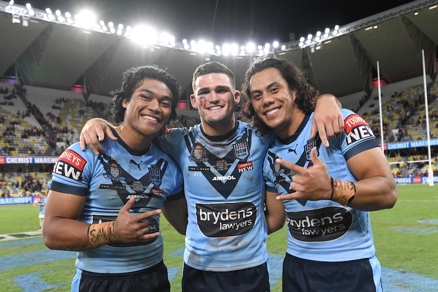 Brian To'o, Nathan Cleary and Jarome Luai stand in a line, hugging