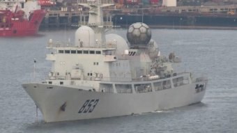 A Chinese AGI spy ship floats in a harbour.