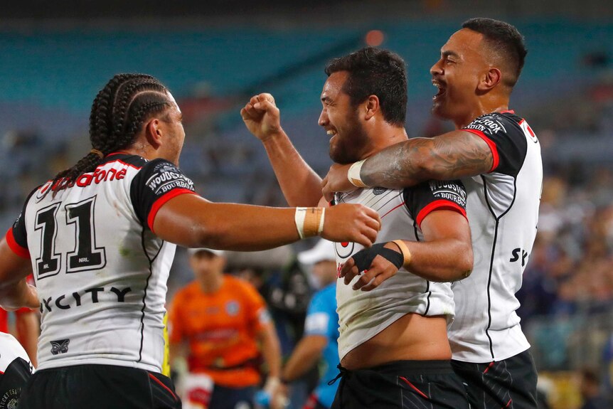 Warriors celebrate a try against the Eels.